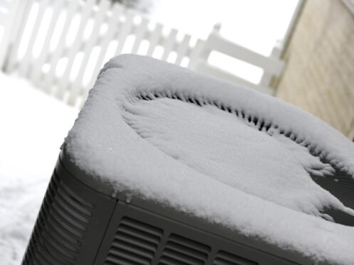 Fresh snow on top of a heat pump