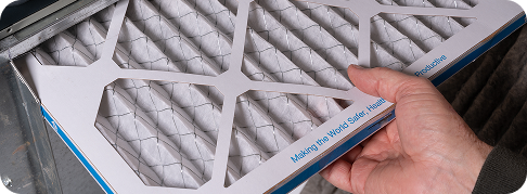 someone holding a clean air filter
