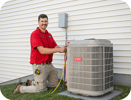 Haley Comfort Systems technician servicing a Bryant air conditioning unit outside a home.